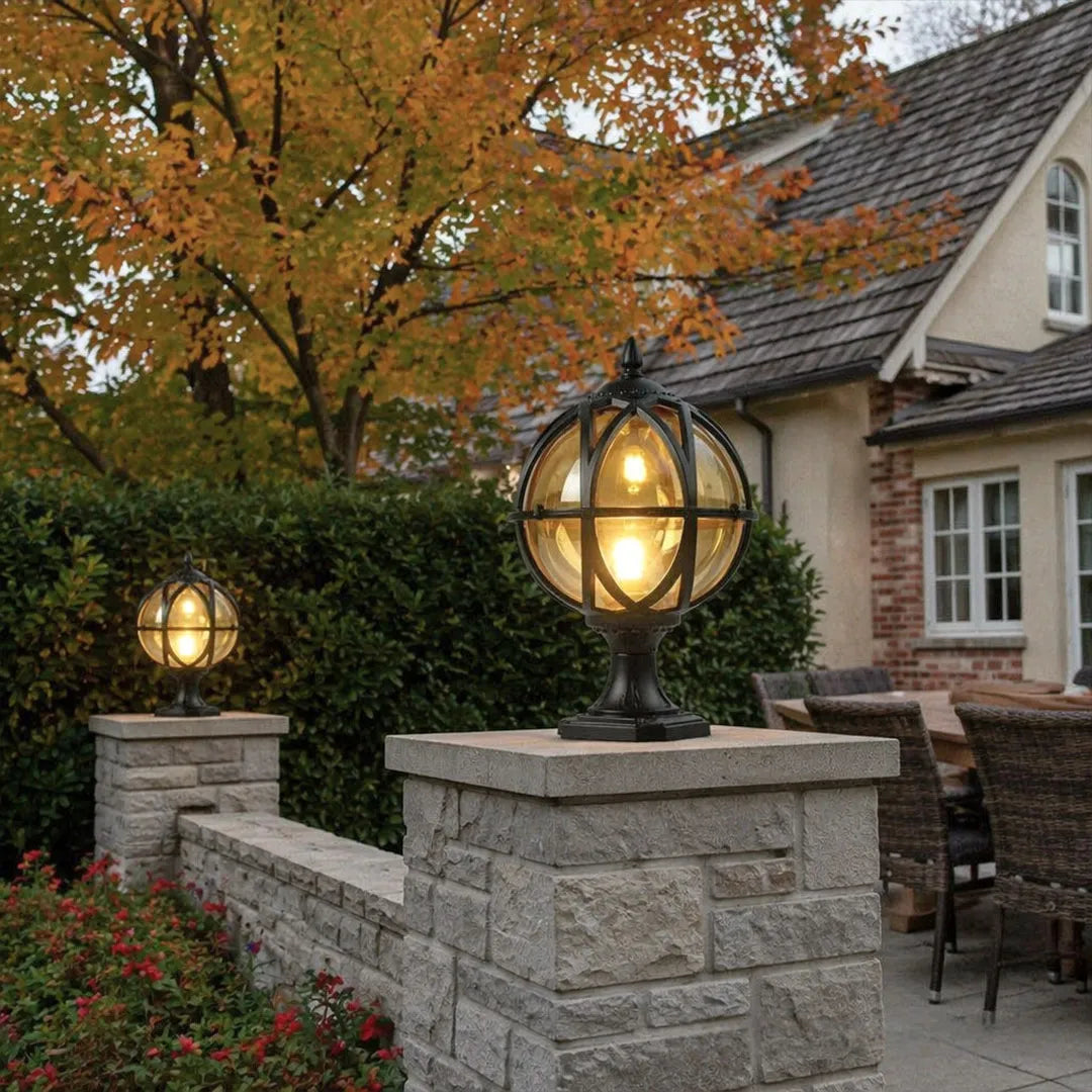 Globe pillar lights adding decorative outdoor lighting along a driveway with classic globe lantern styling.