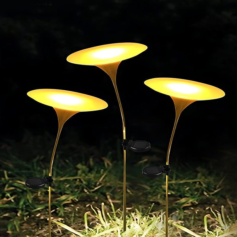 Glowing mushroom garden light enhancing a garden pathway with whimsical, yellow glow.