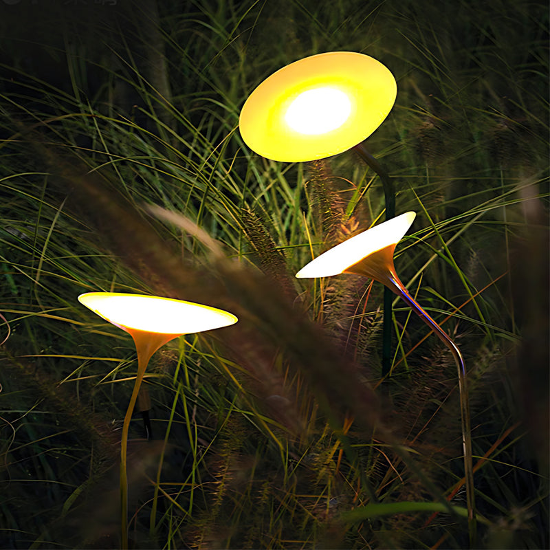 Glowing mushroom garden light casting a gentle glow near a dark garden bed.