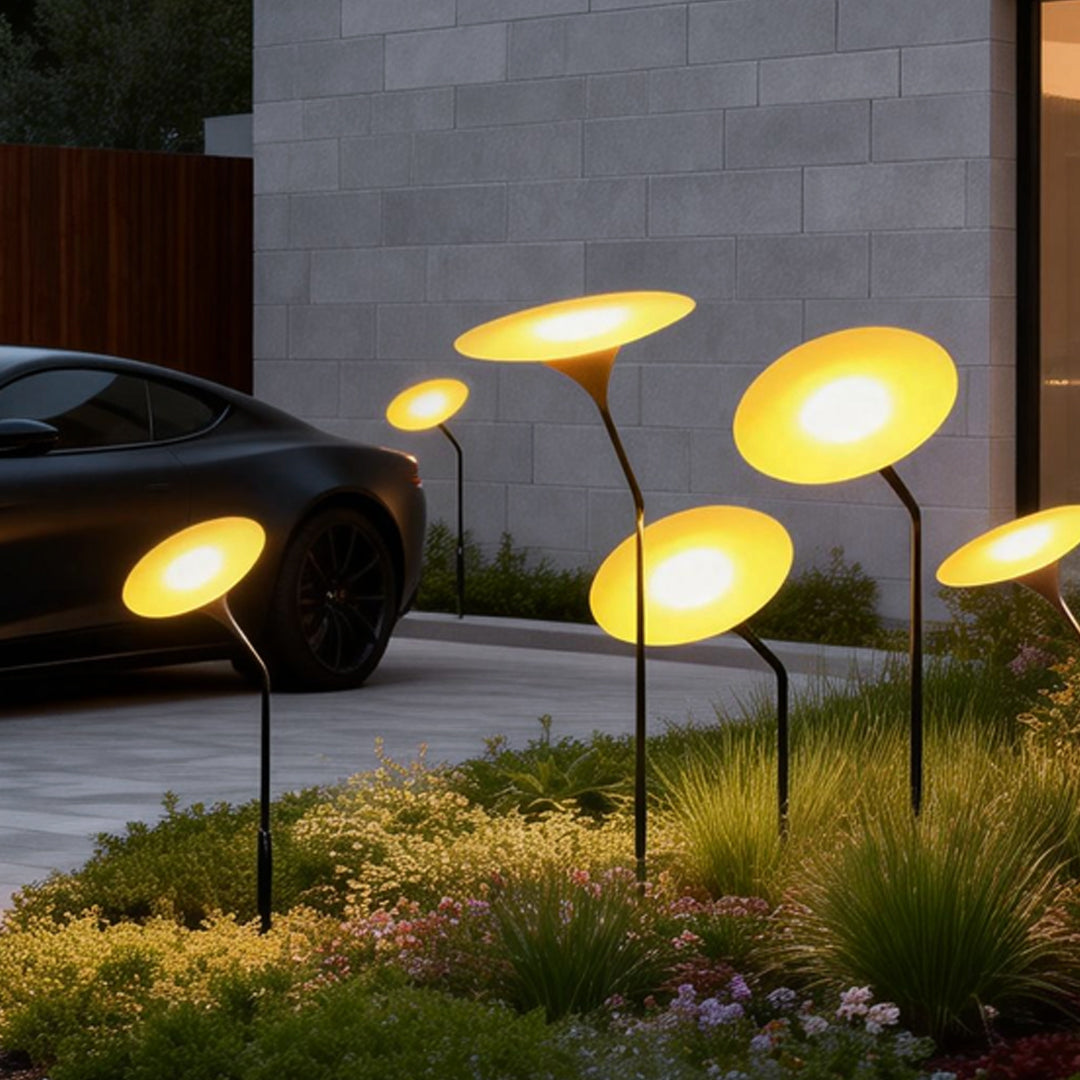 Glowing mushroom garden light illuminating a modern driveway with warm, ambient glow.