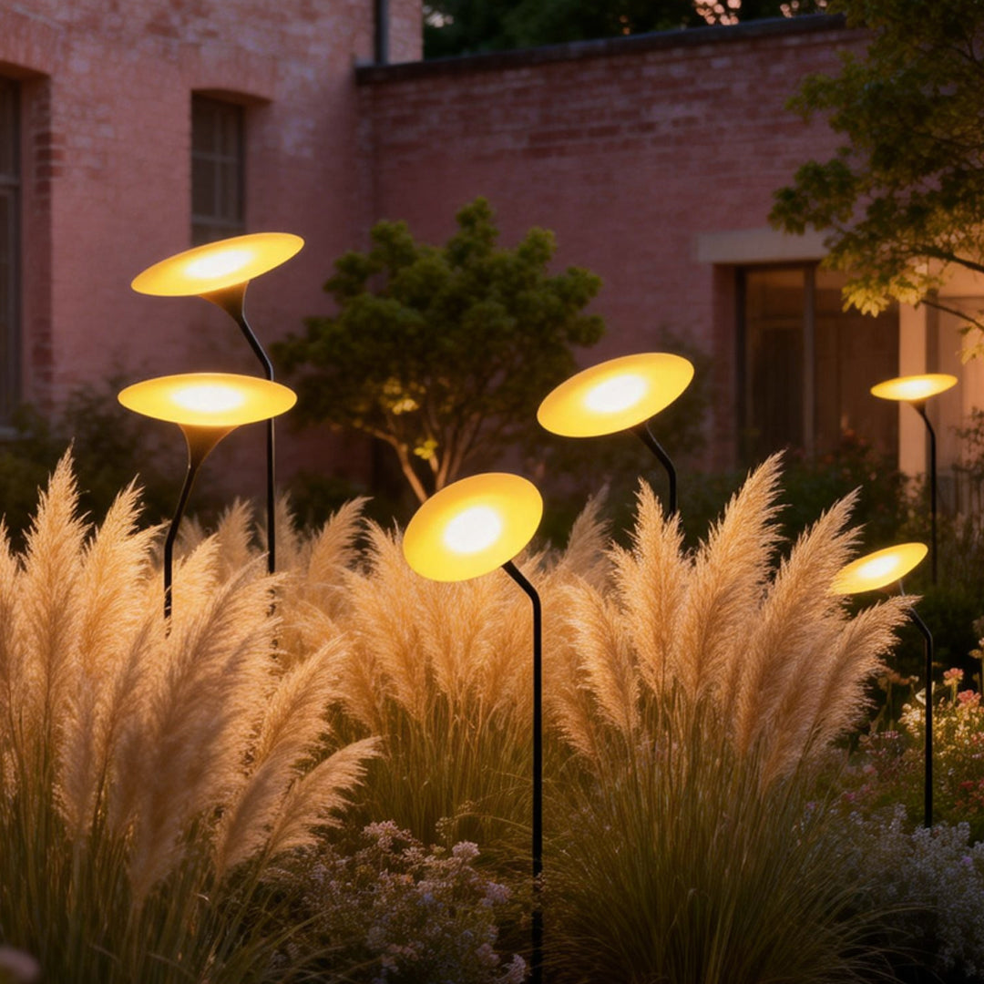 Glowing mushroom garden light providing soft illumination among ornamental grasses.