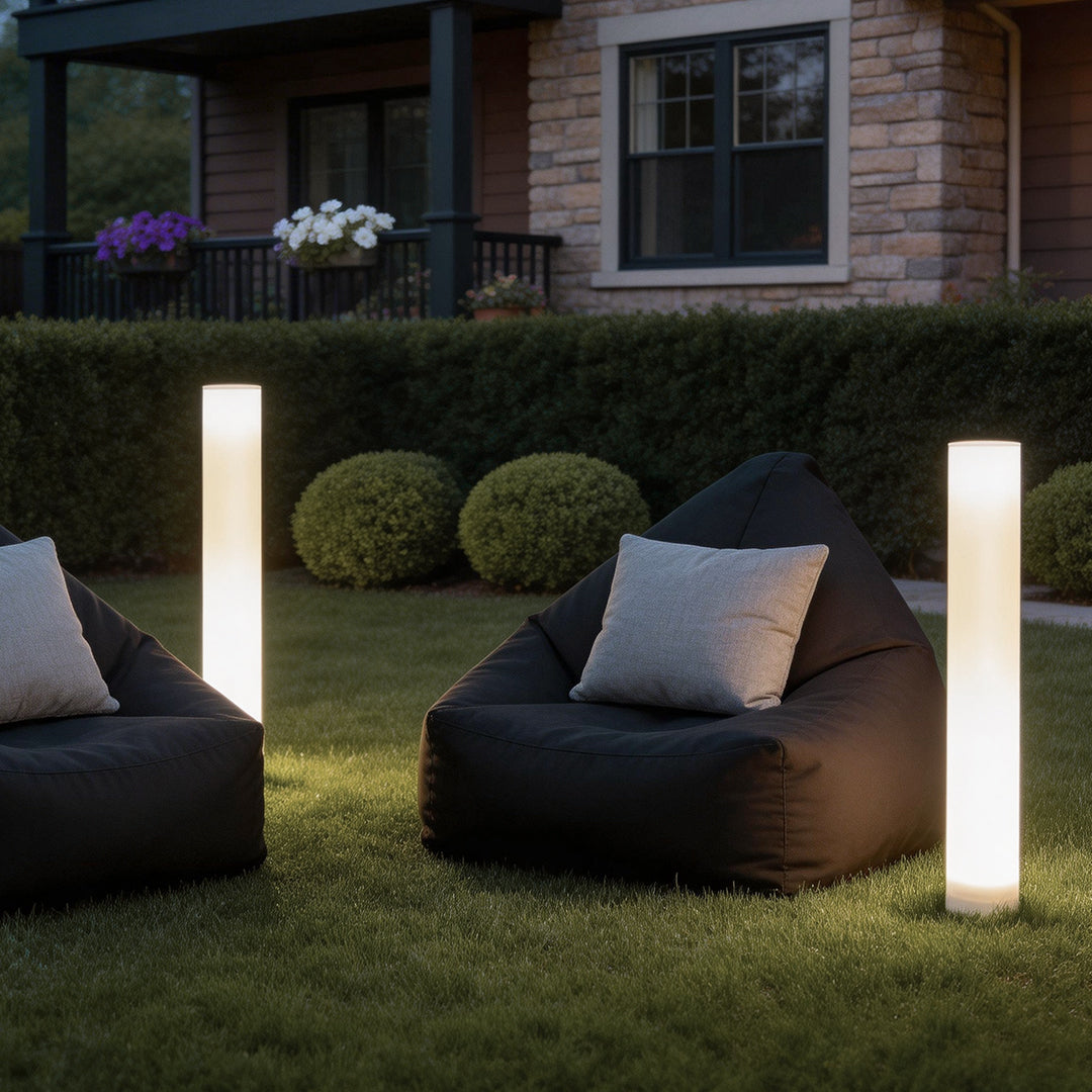 Glowing pillar light illuminating a modern garden lawn with soft ambient glow.