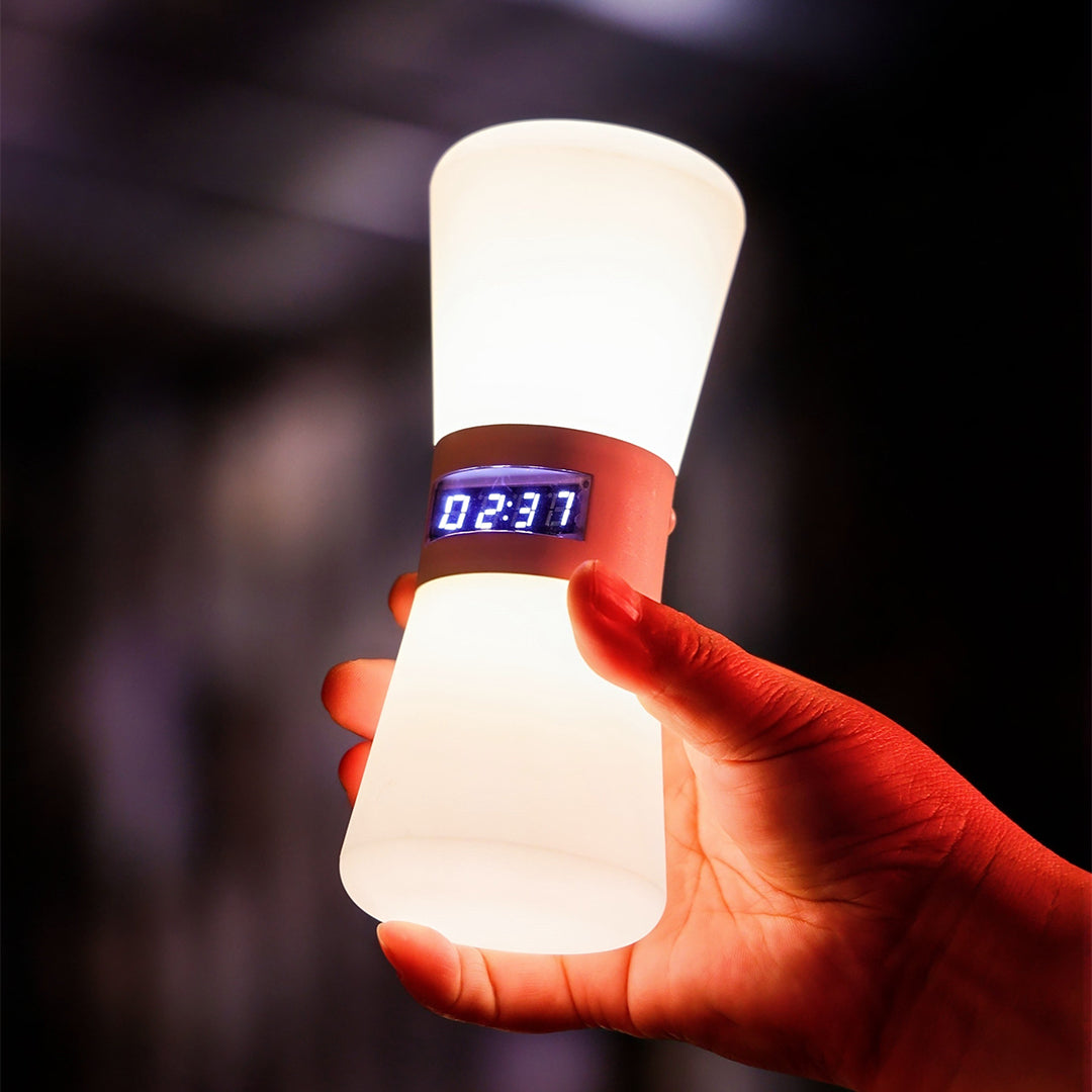 Glowing white USB rechargeable table lamp with red accent lighting showing color-changing feature