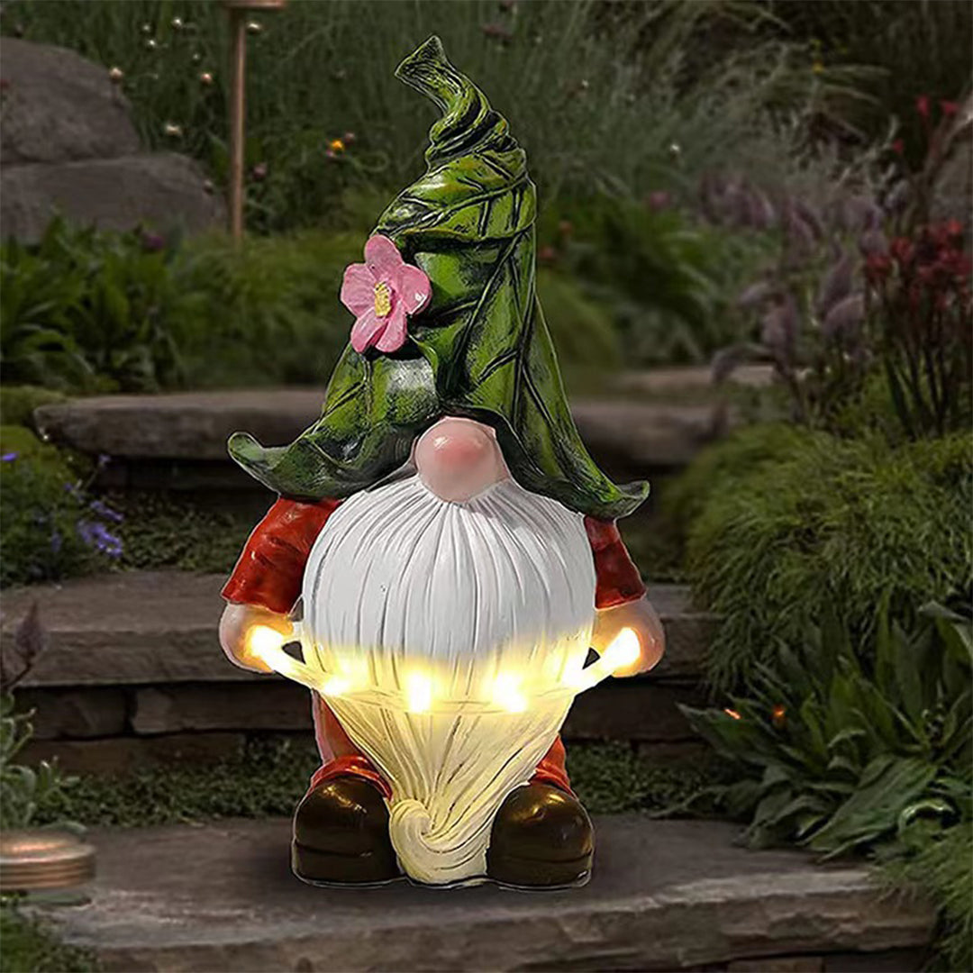 Gnome with illuminated belly light positioned on garden path creating magical evening atmosphere