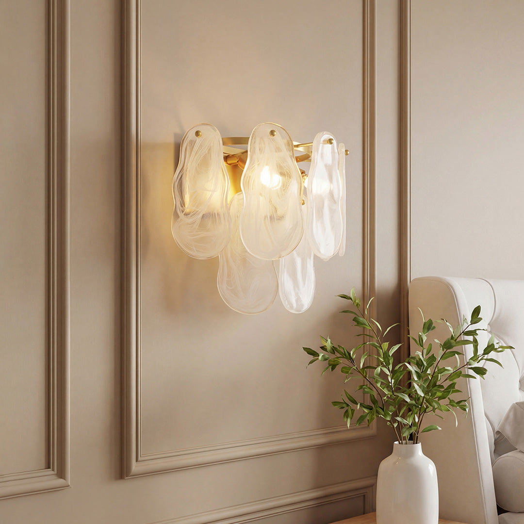 Luxury art deco wall lights featuring textured leaf glass petals and gold finish on beige wall.