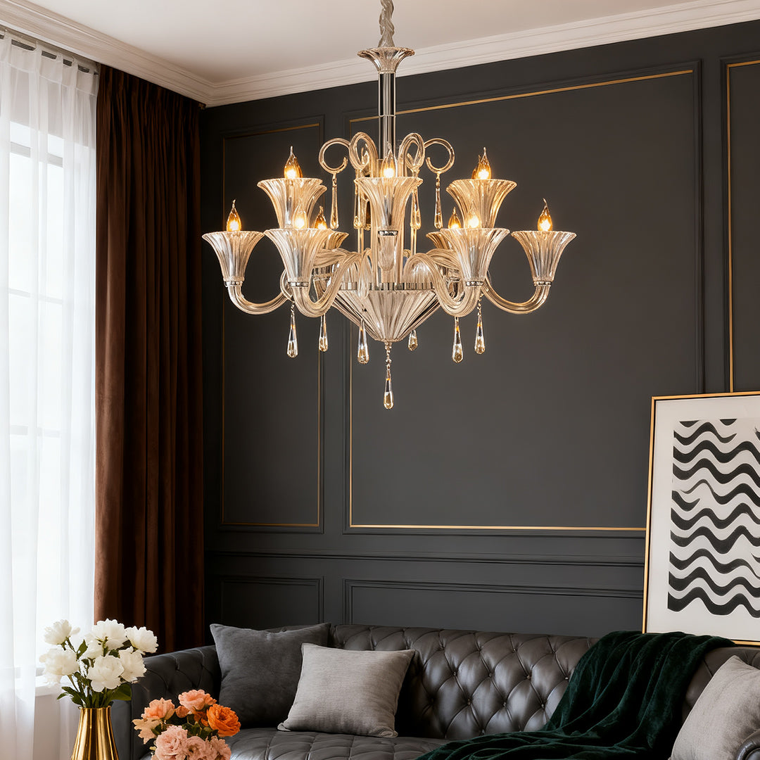 Gold art glass chandelier illuminating sophisticated living room with dark walls and tufted furniture.