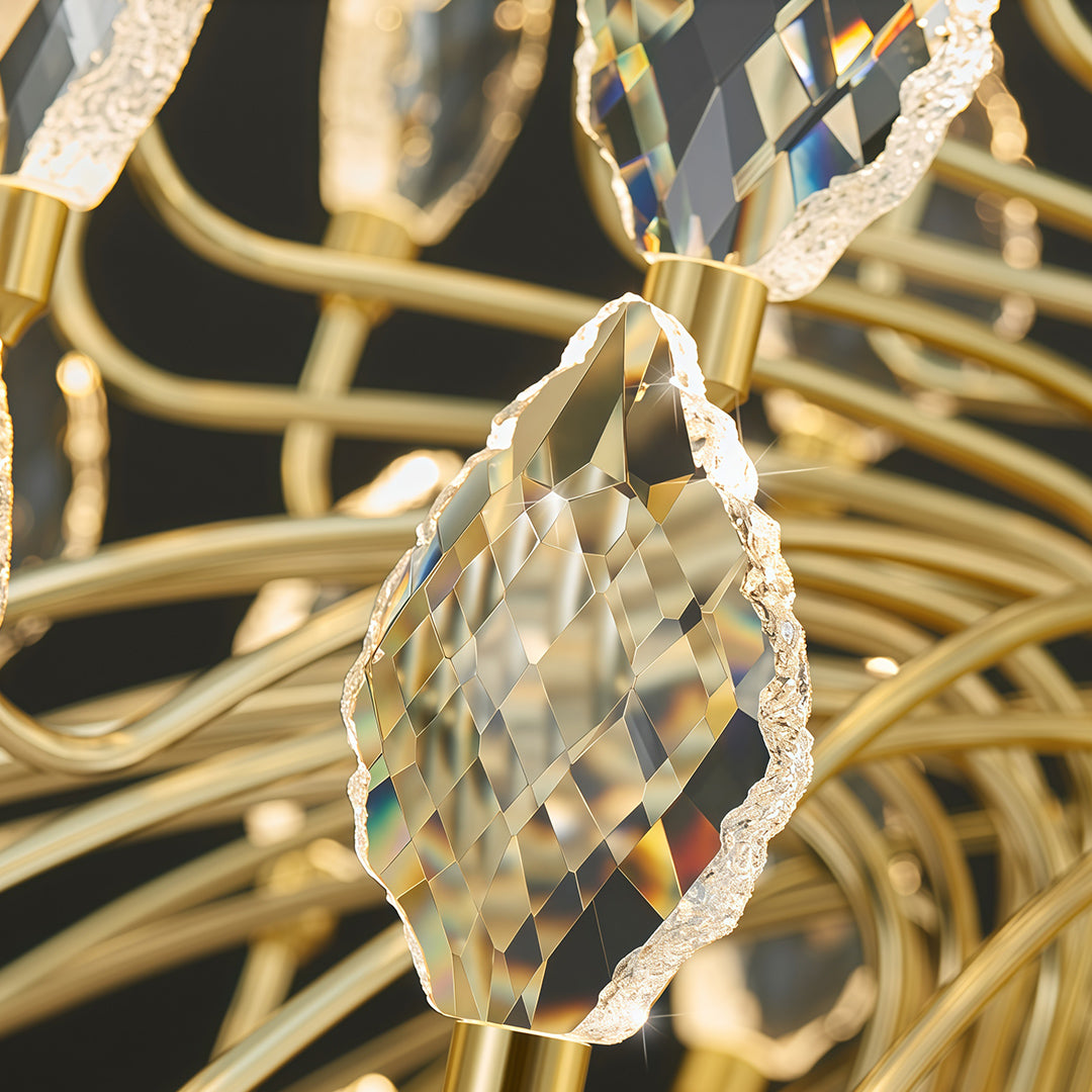 Detailed view of gold base and hanging crystals on LED chandelier.