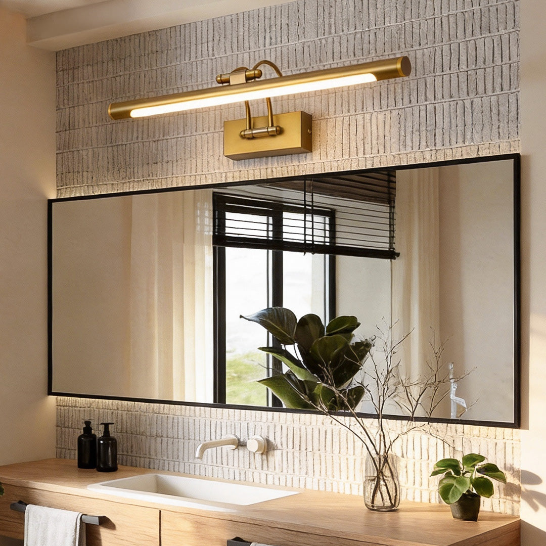 Gold bathroom vanity lighting providing elegant illumination above a stylish mirror.