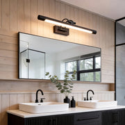 Gold bathroom vanity lighting illuminating a modern double sink vanity with warm glow.