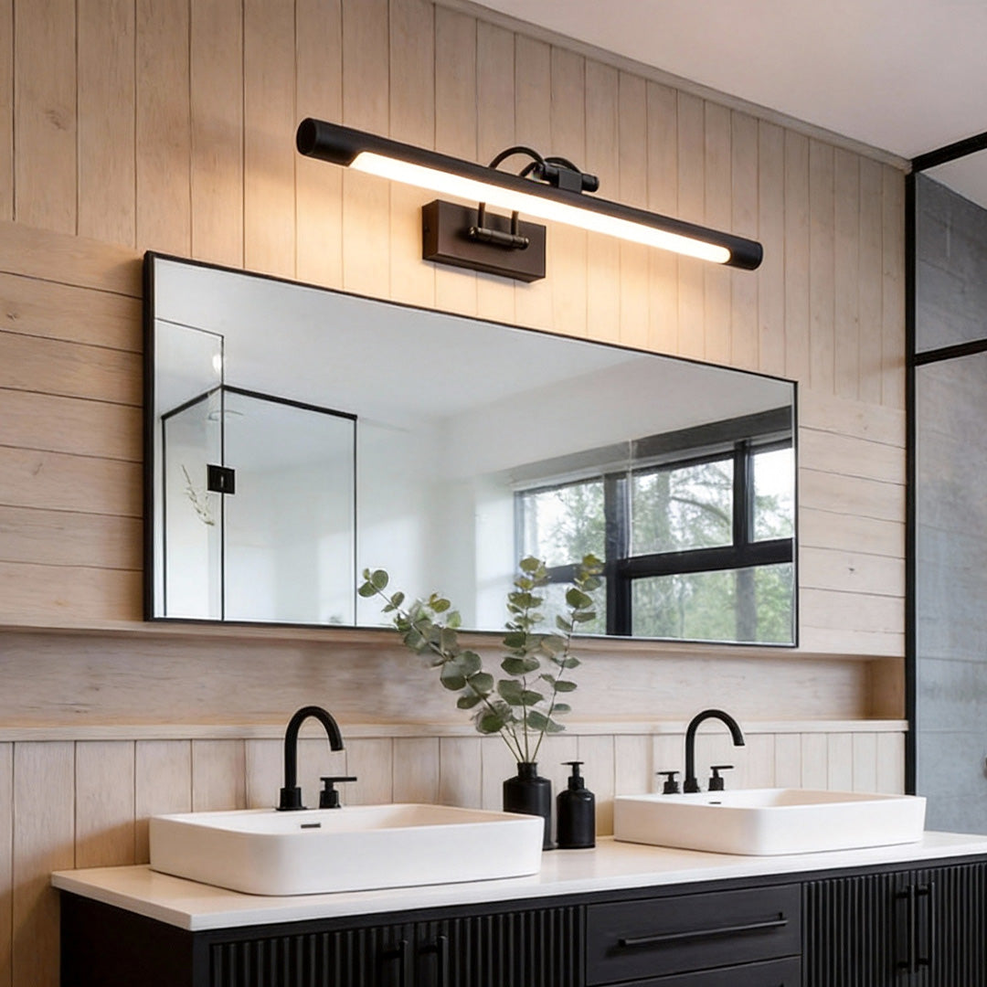 Gold bathroom vanity lighting illuminating a modern double sink vanity with warm glow.