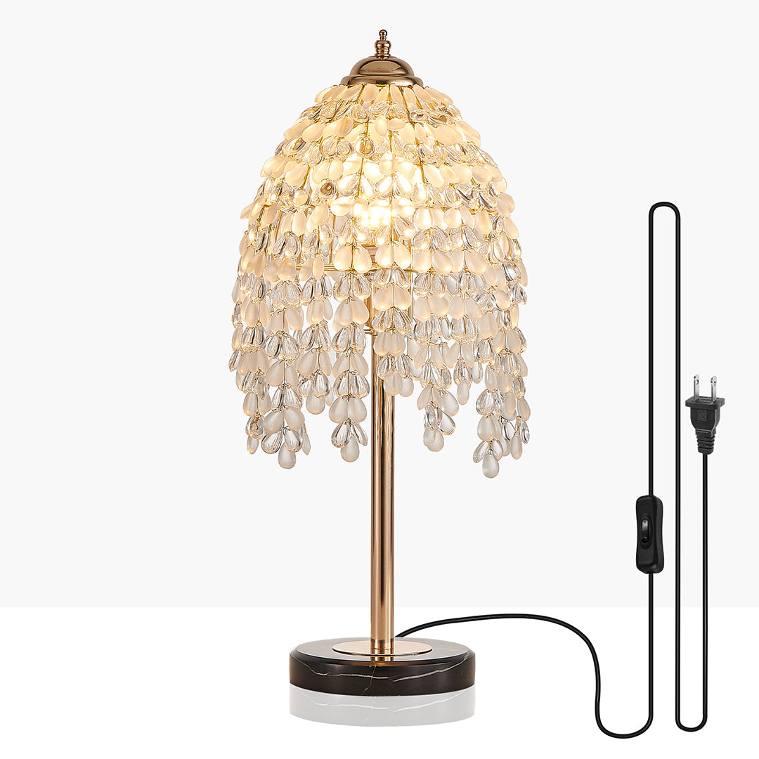 Gold bedside table lamp with glass shade chandelier design featuring adjustable height and decorative crystal tassel shade.