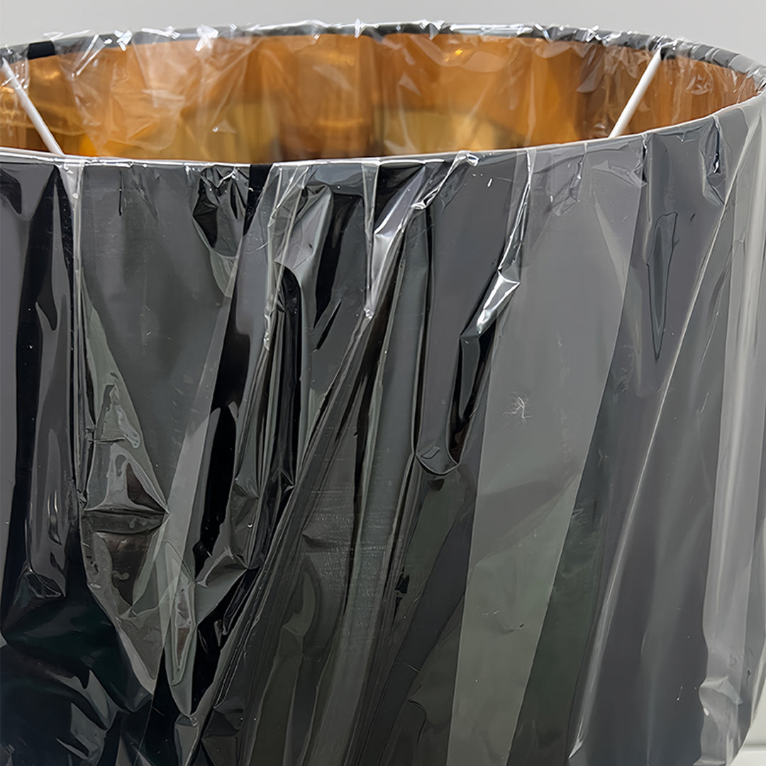 Detailed view of gold and black table lamp base showing intricate metalwork craftsmanship