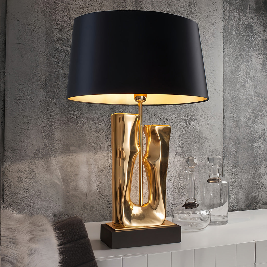 Gold and black table lamp creating ambient lighting in industrial-style interior setting