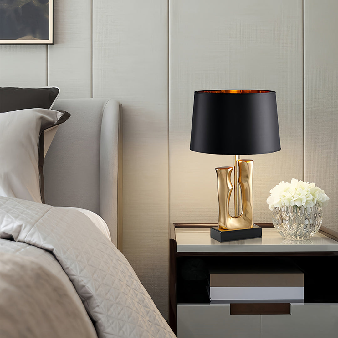 Stylish gold and black table lamp pair illuminating modern bedroom with warm lighting