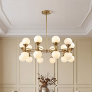 Elegant gold bubble glass chandeliers featuring frosted white globes in a classic room with wainscoting.