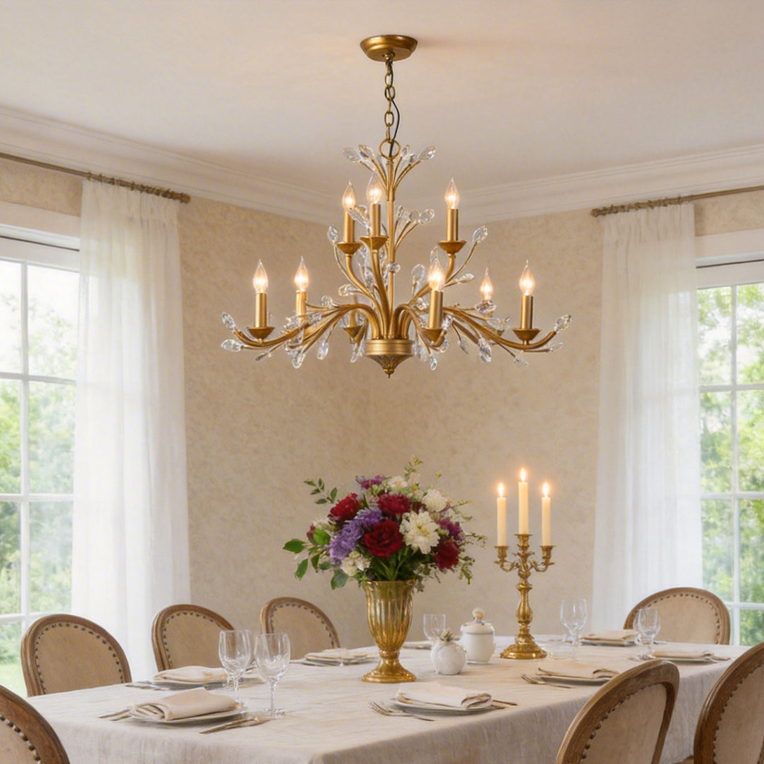 Gold candlestick chandelier with a close-up of its ornate candle holders and crystal accents.