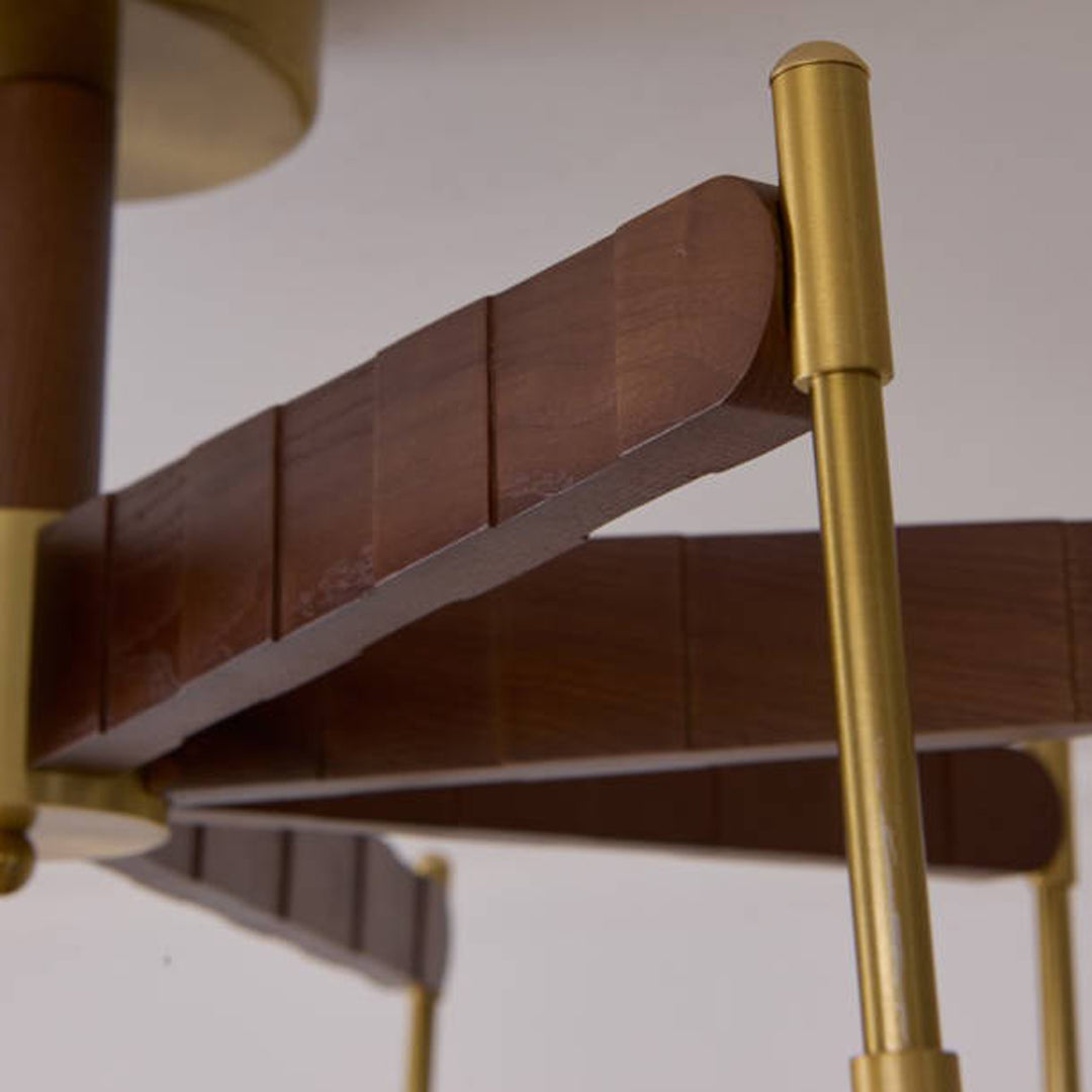 Detailed view of chandelier structure featuring gold metal arms and wooden accent elements.