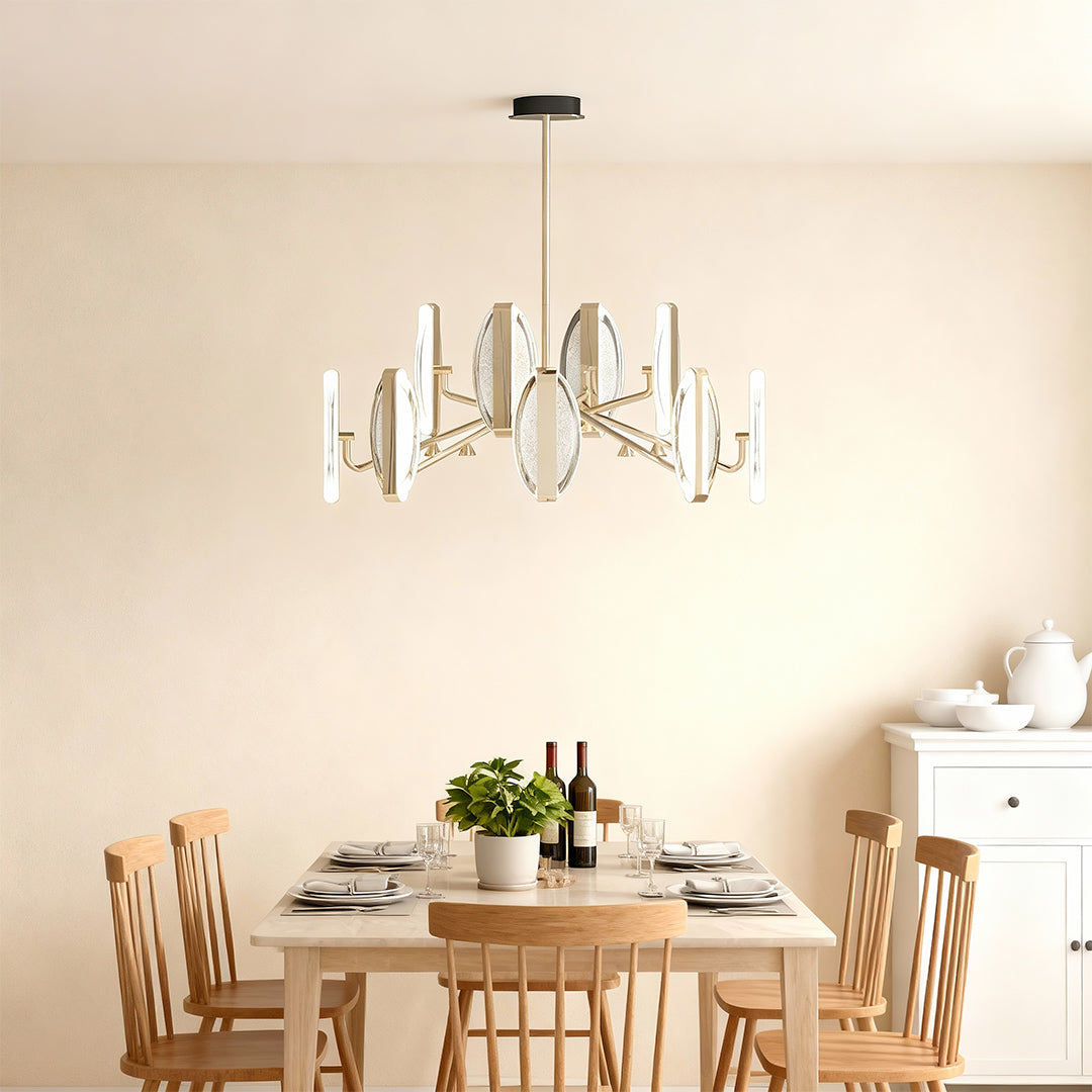 Gold chandelier modern providing ambient lighting above dining area in bright kitchen with natural wood furniture
