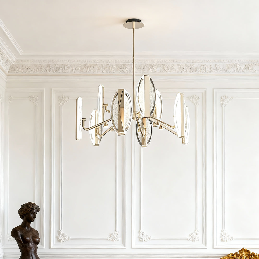 Gold chandelier modern hanging in elegant room with white wainscoting and classical architectural molding details