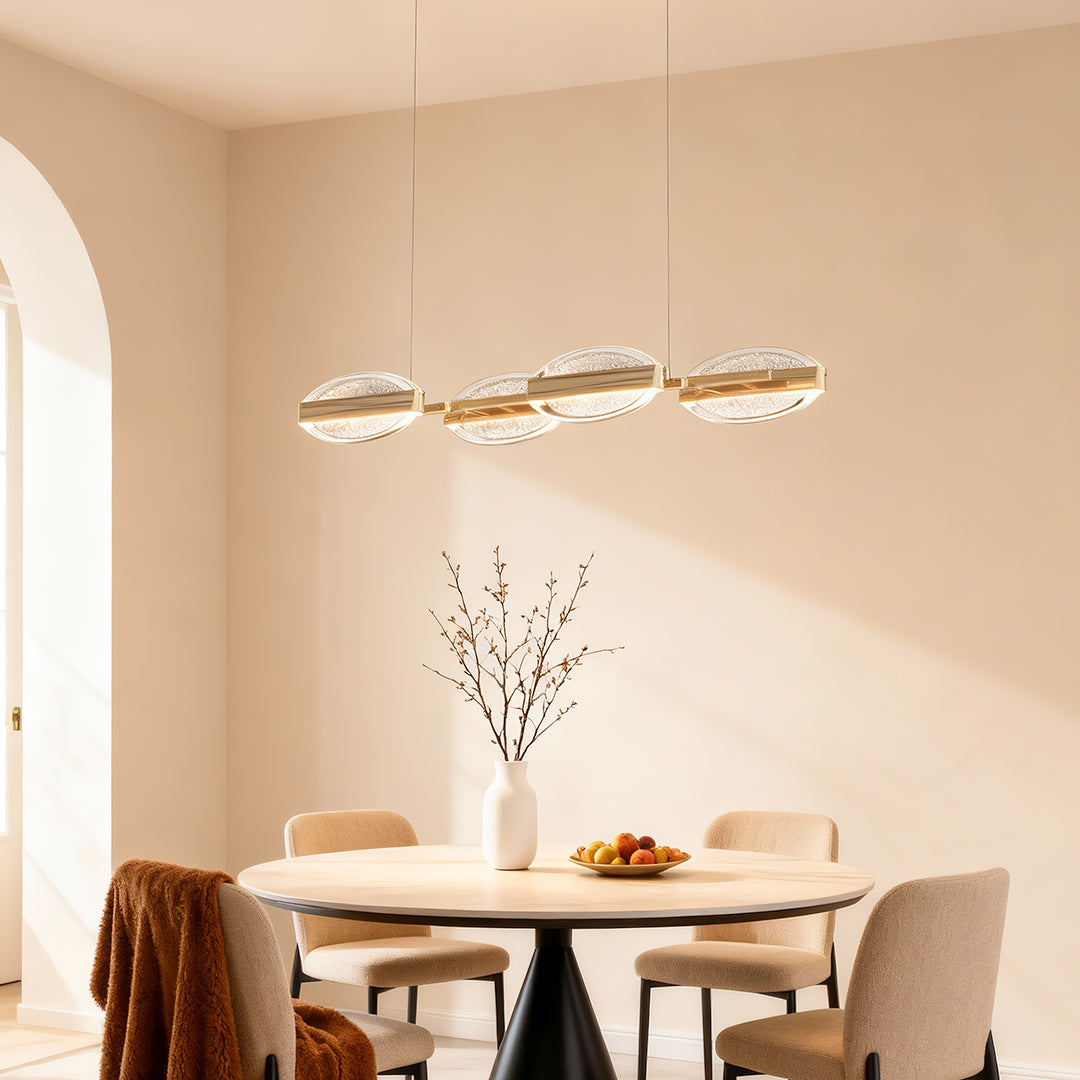 Gold chandelier modern illuminating warm dining space with wooden chairs and archway in contemporary interior