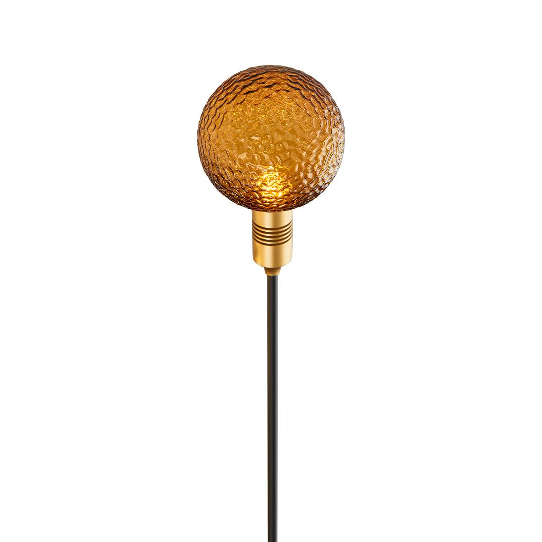 Warm golden crackle-glass globe stake light offering soft illumination for path landscape lighting.