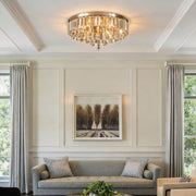Gold crystal flush mount light illuminating a modern living room with elegant crystal details.