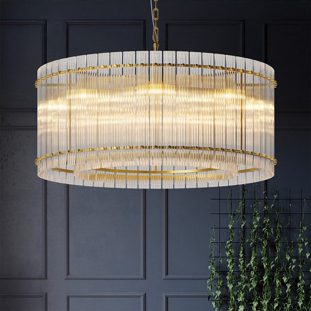 Gold crystal glass lamp shade chandelier glowing in a refined gray dining room with minimalist decor.