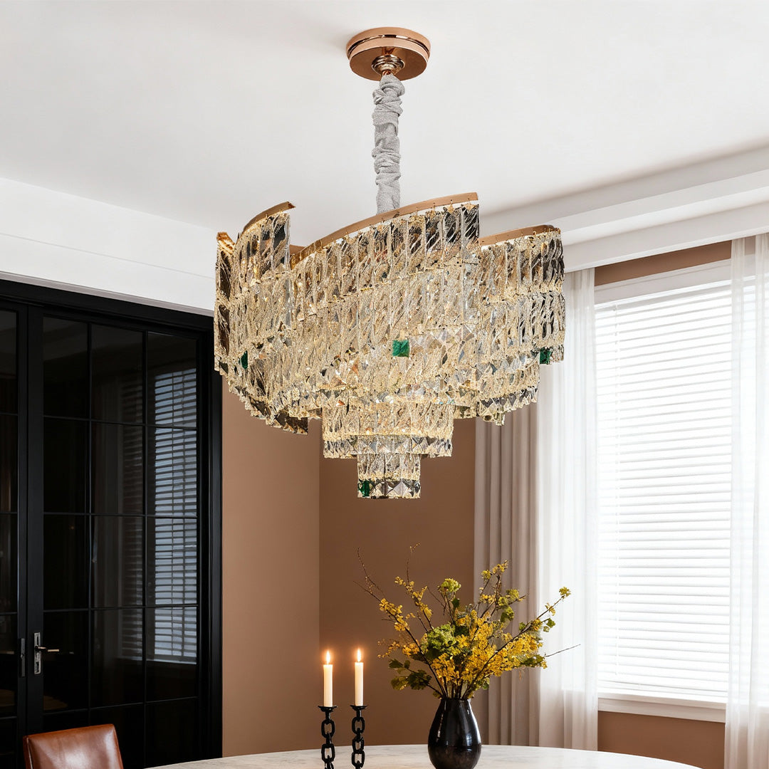 Contemporary interior with gold crystal pendant chandelier and soft lighting.