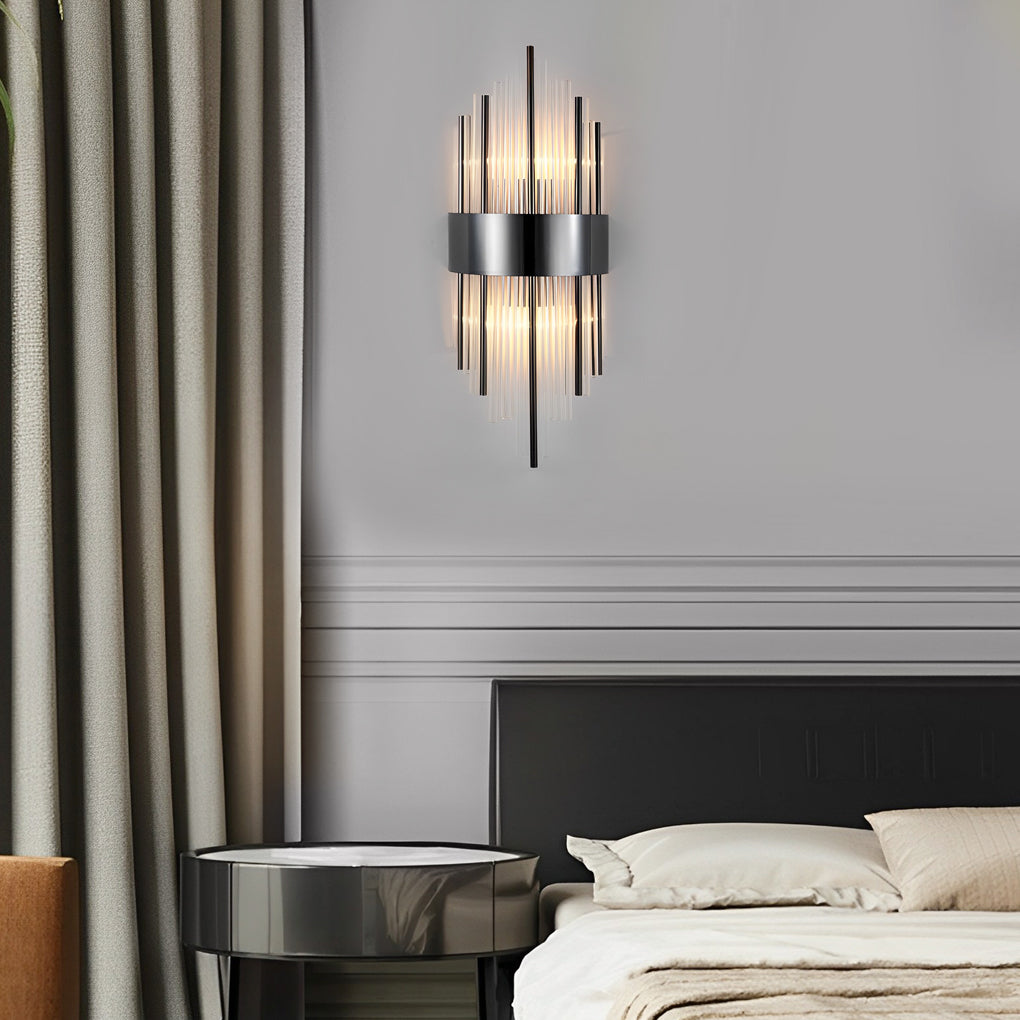 Gold and crystal wall sconces with a modern design, providing warm light in a stylish bedroom.