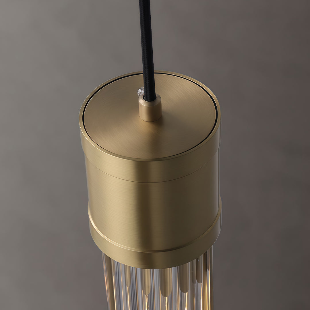 Gold cylinder pendant light with brushed brass finish detail.