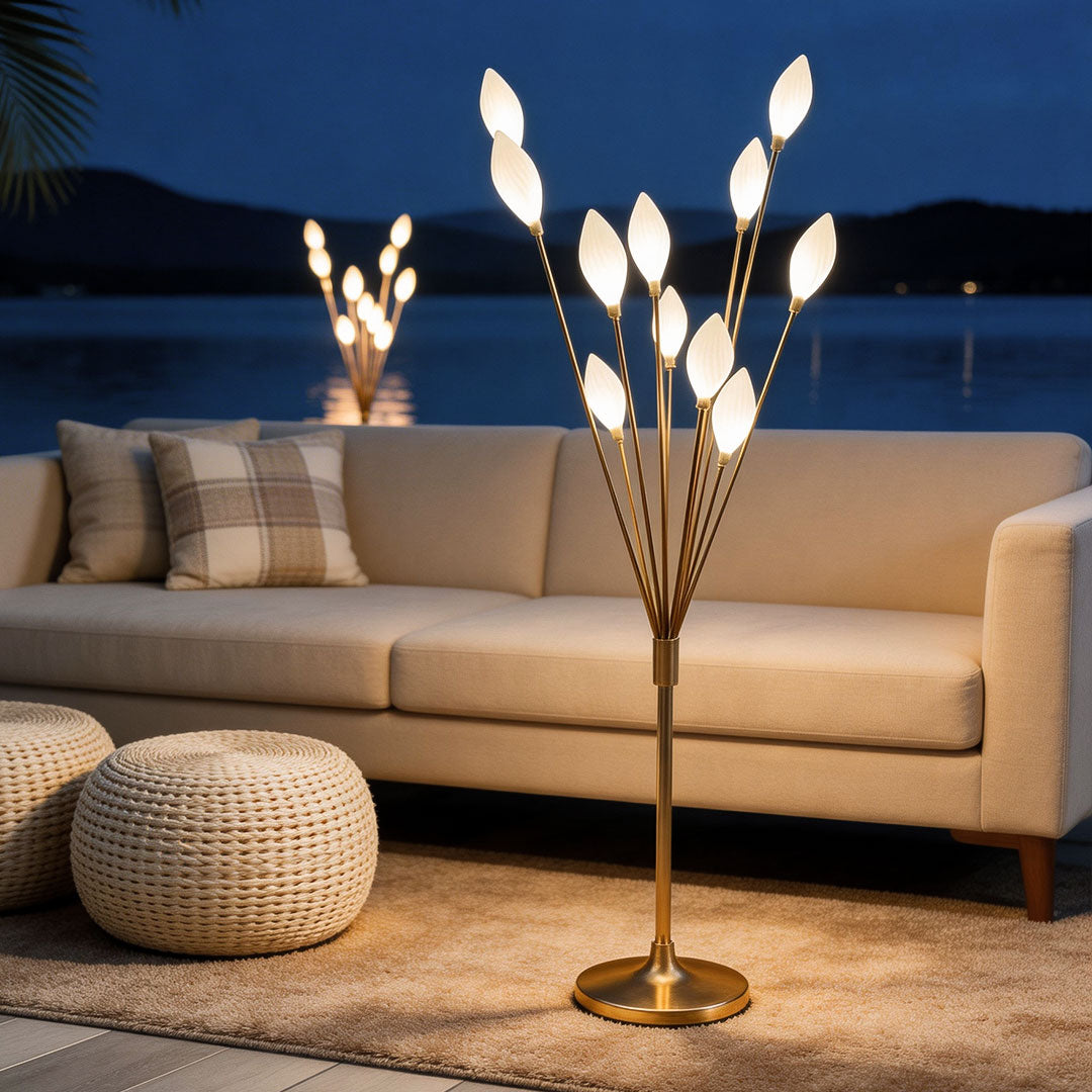 Gold decorator floor lamps on a balcony deck at night with a cozy sofa and a calm lake background.