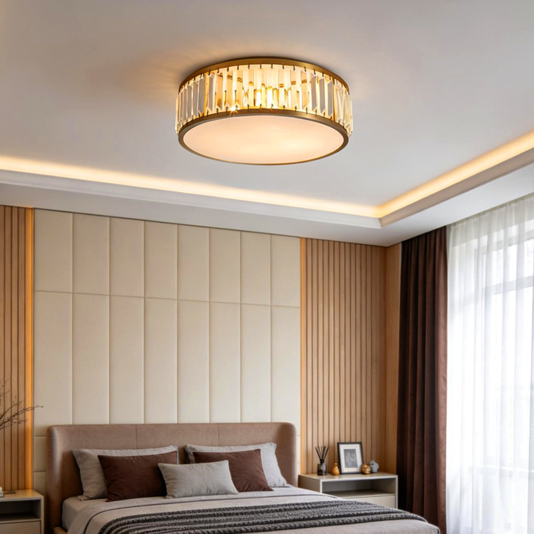 Gold drum ceiling light installed in a modern bedroom with warm ambient lighting.