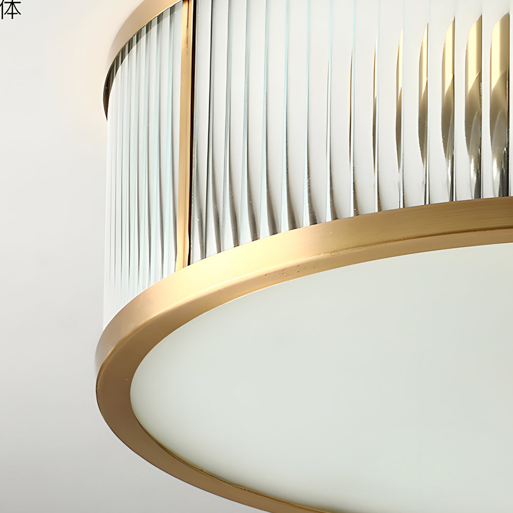 Gold drum ceiling light with a close-up of its hanging mechanism and gold details.