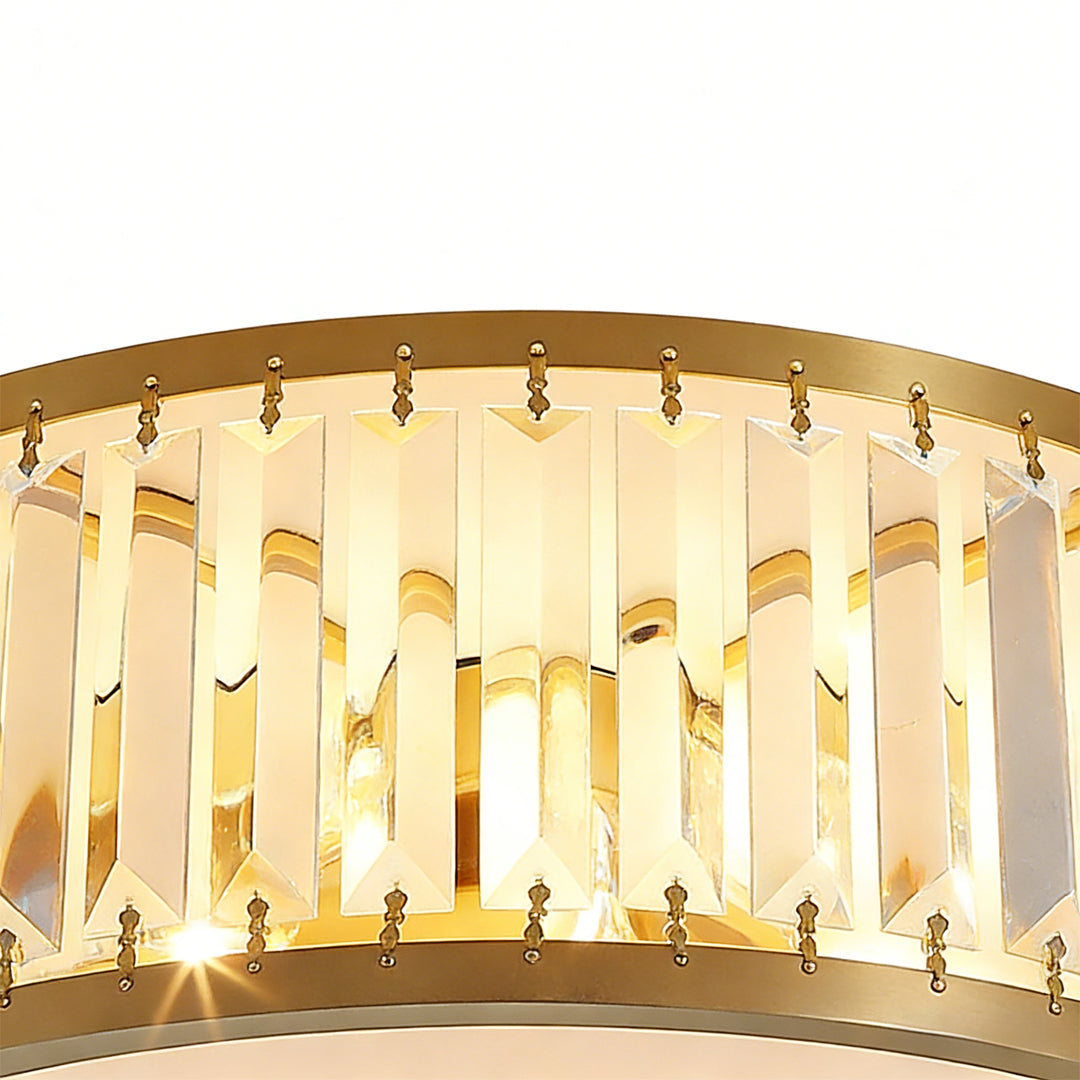 Close-up detail of the crystal and metal design on a gold drum ceiling light.