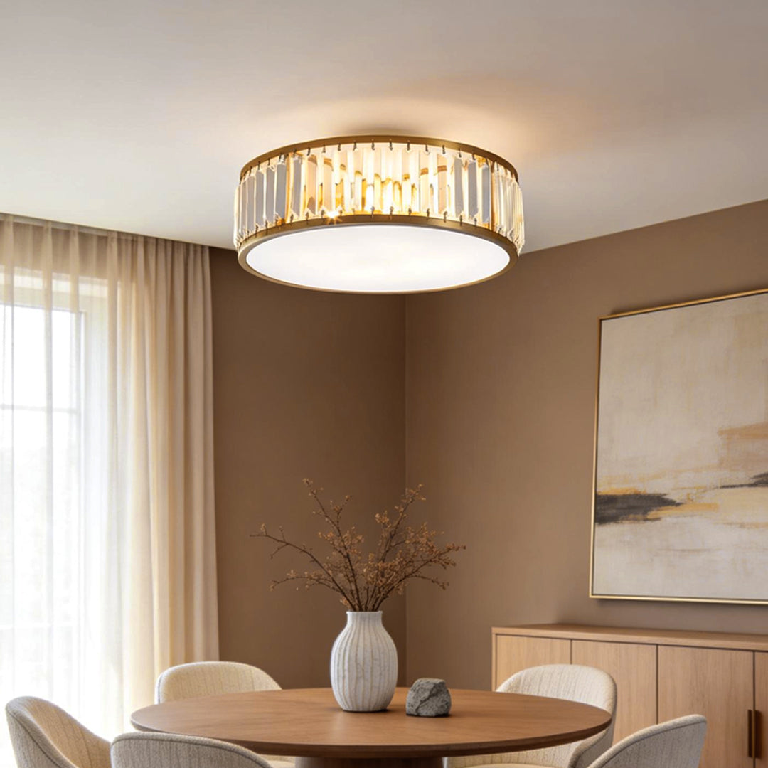 Gold drum ceiling light mounted above a dining table in a contemporary dining room.