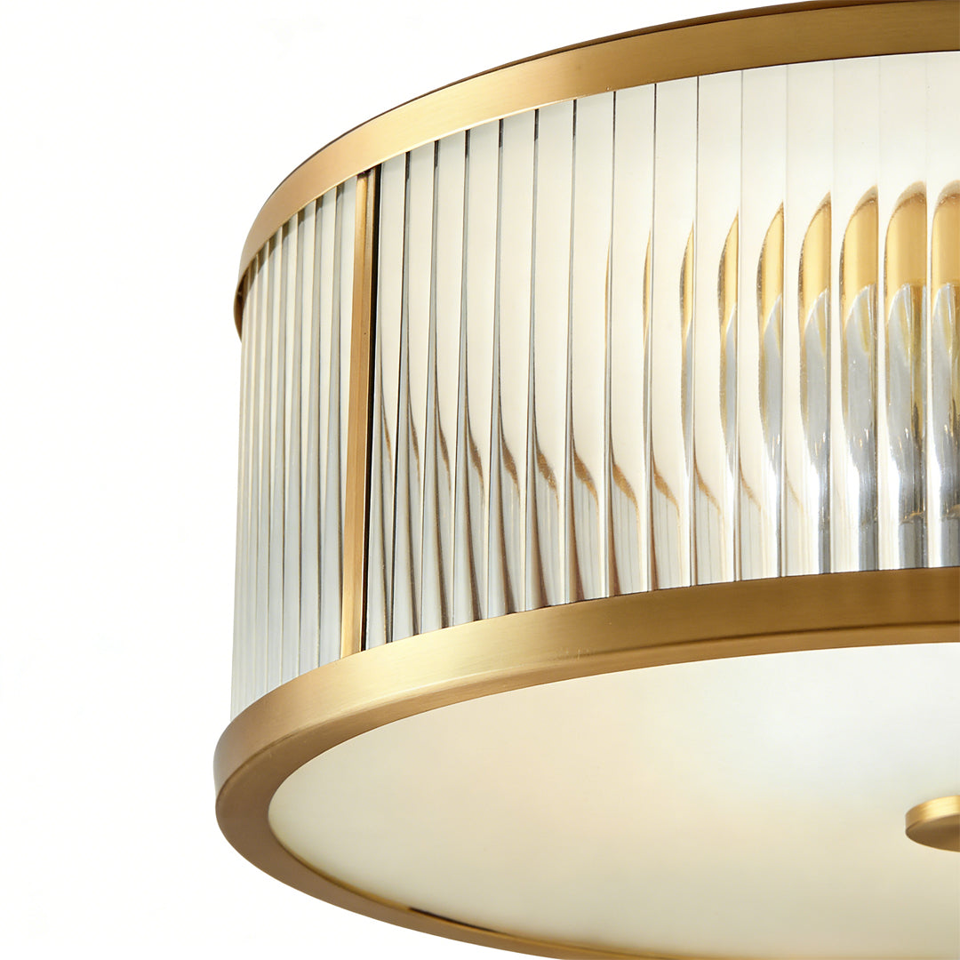 Gold drum ceiling light with a sleek design, providing elegant light in a modern living area.