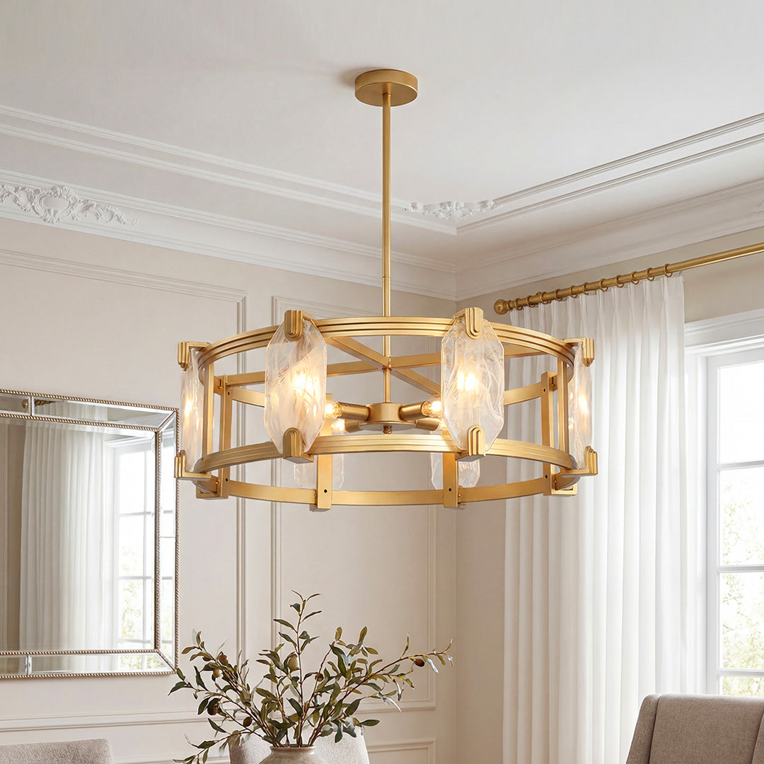 Elegant gold round glass chandelier featuring a drum frame with textured clear glass panels in a sophisticated room.