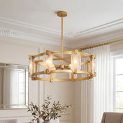 Elegant gold round glass chandelier featuring a drum frame with textured clear glass panels in a sophisticated room.