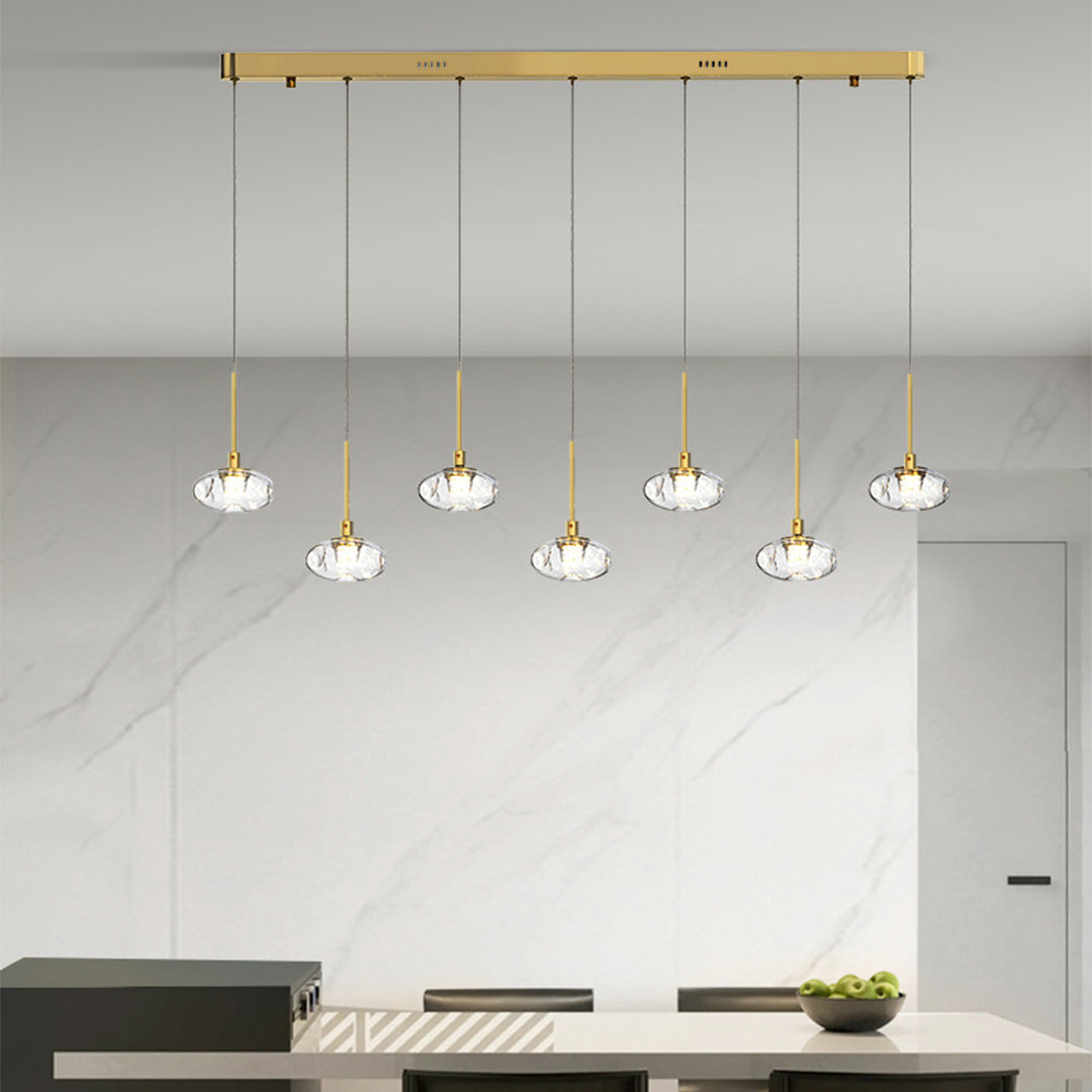 Luxurious multi light pendant lighting with gold finish illuminating upscale kitchen island with warm ambient glow