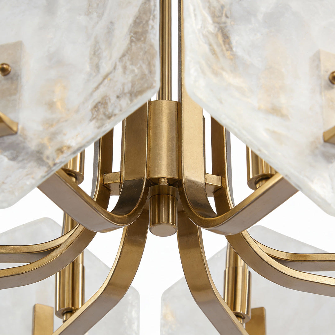 Luxurious gold geometric chandelier with intricate brass arms and elegant white marble-like glass shades.