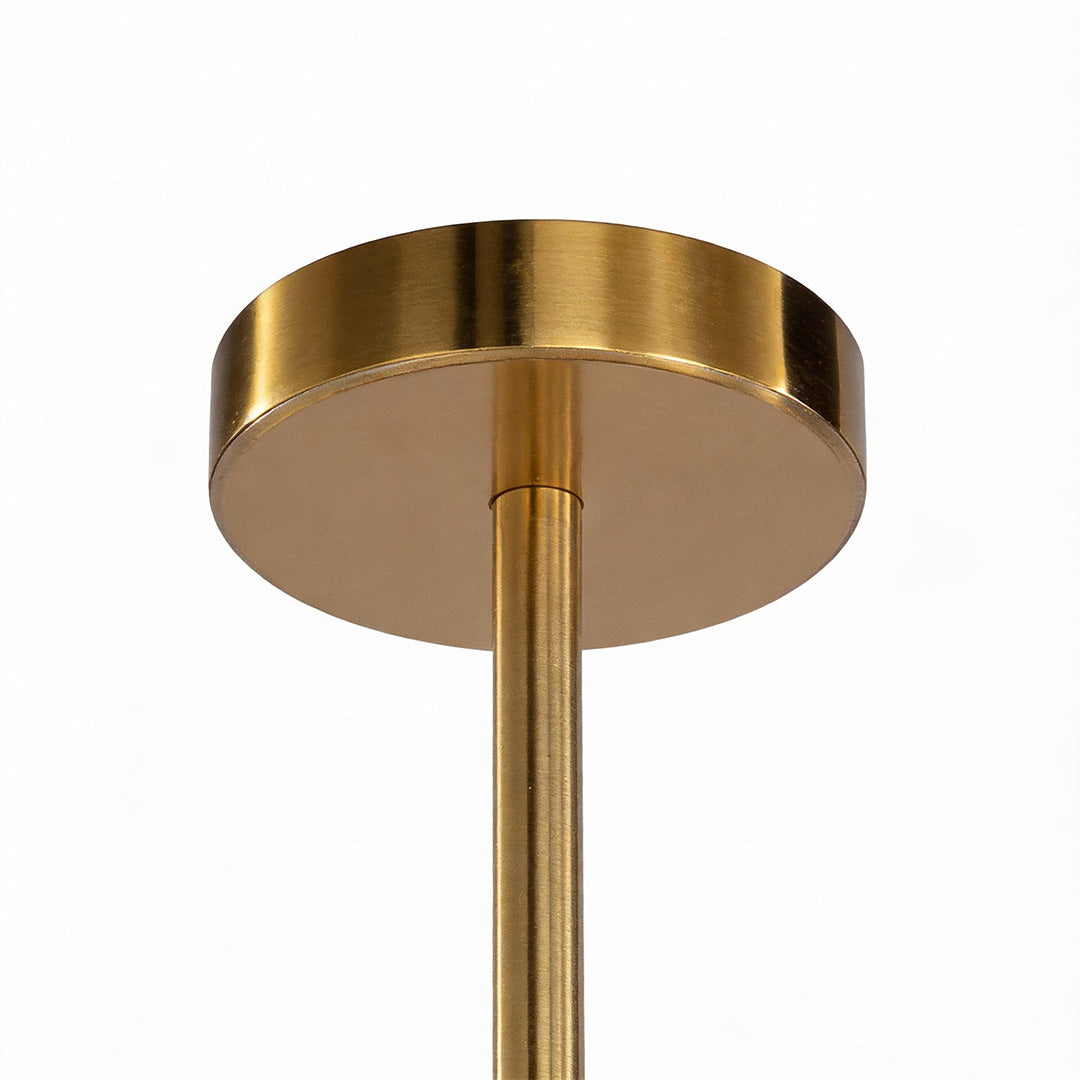 Ceiling mount of a gold geometric chandelier featuring a sleek round canopy and polished brass finish.