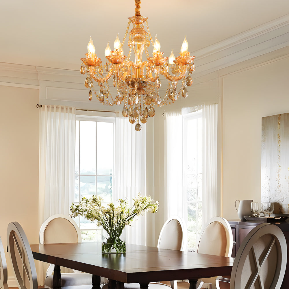 Gold glass candlelight chandelier hanging above a dining table in a bright, elegant dining room.