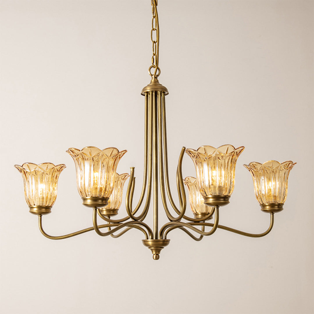 Gold glass chandelier with textured amber shades and polished brass arms in vintage style
