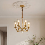 Elegant gold glass drop chandelier featuring clear cylindrical shades and a modern geometric frame suspended from an ornate ceiling medallion.