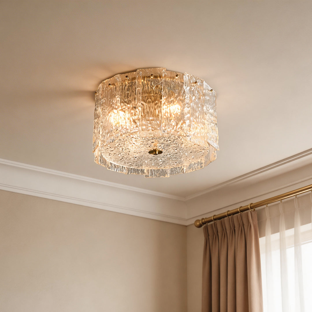 Modern glass flush mount lighting with textured ice glass panels and a gold brass base.