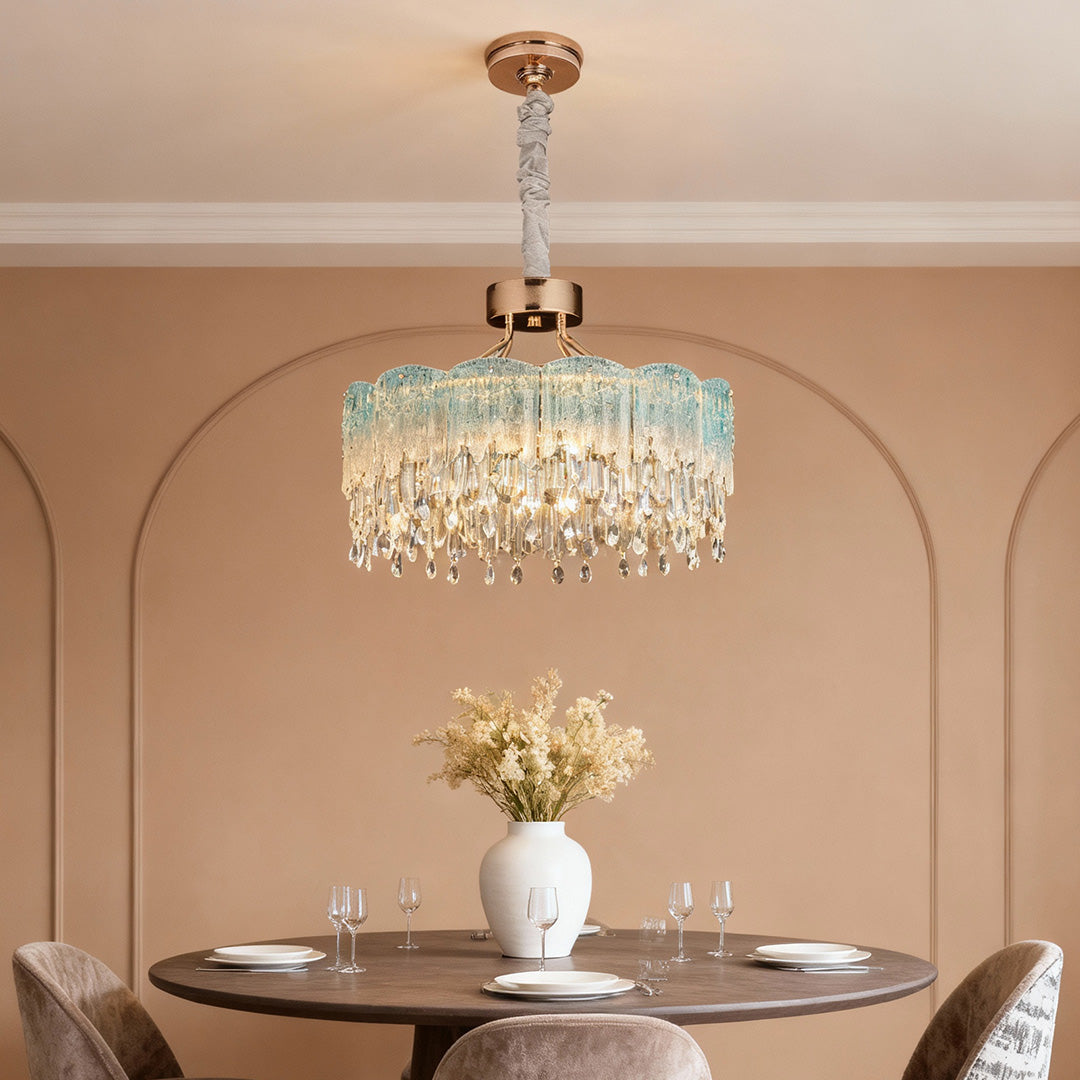 Round gold glass fringe chandelier adding luxury glow to dining area.