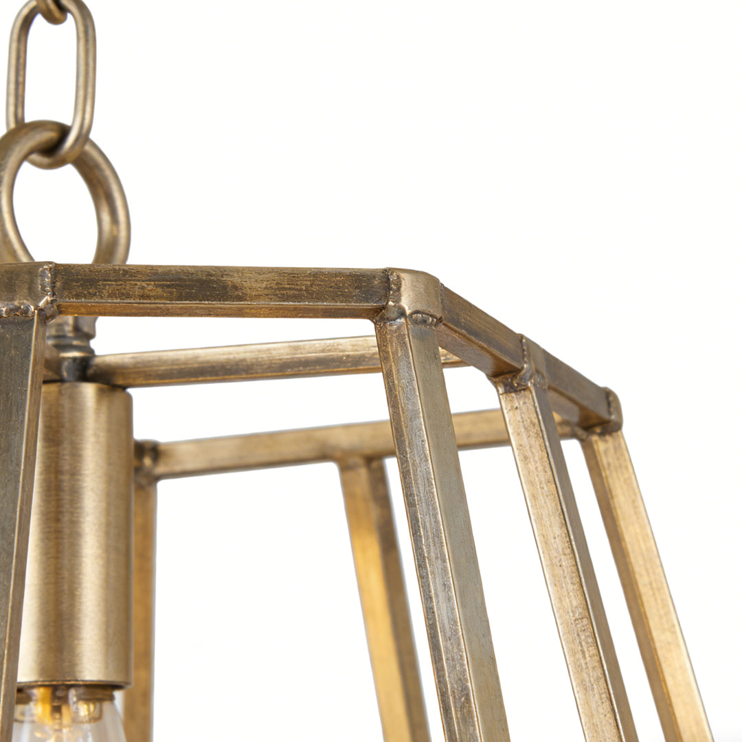 Detailed view of a gold hanging pendant light featuring a geometric frame and cylindrical bulb holder.