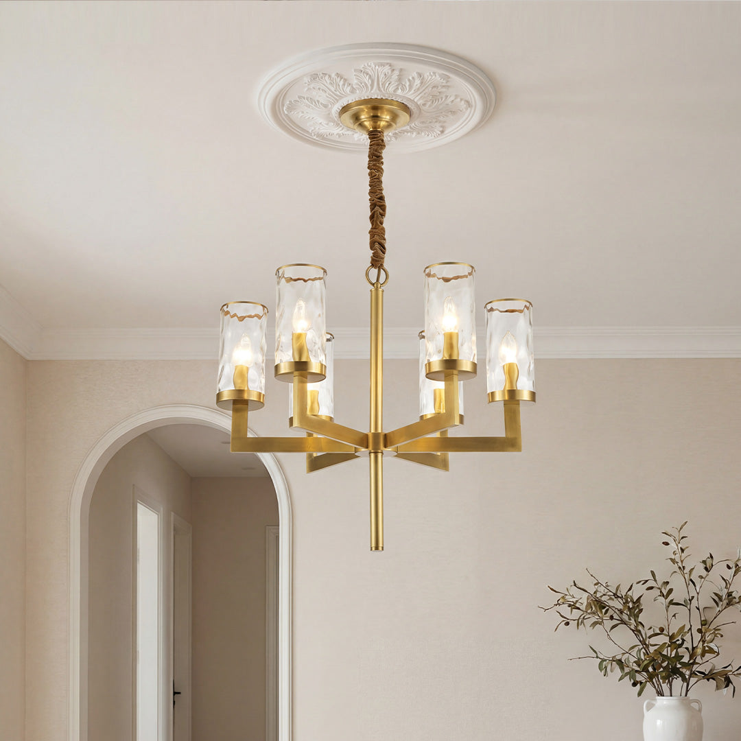 Elegant gold island chandelier modern design featuring angular arms and textured cylindrical glass shades suspended from a classic ceiling medallion.
