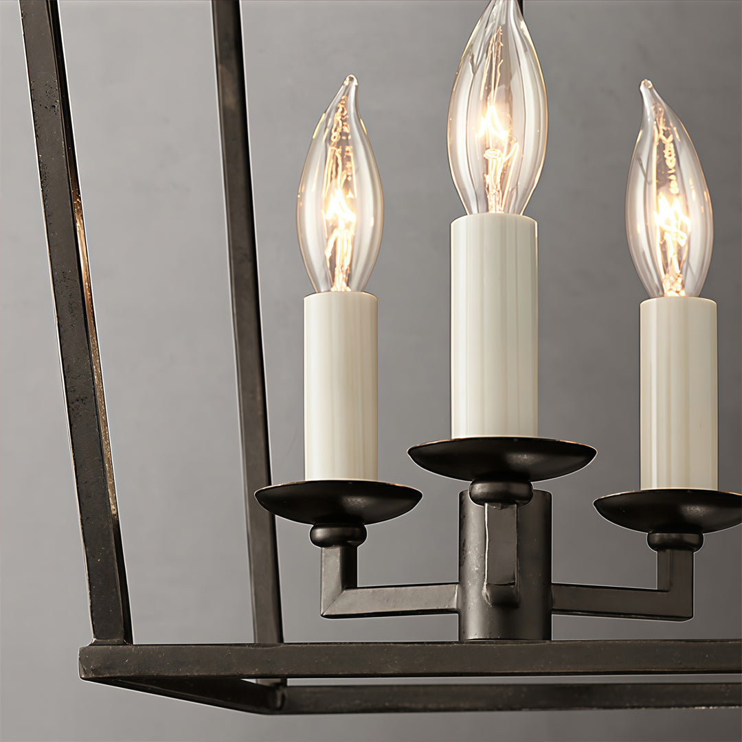 Gold lantern chandelier close-up showing candle style bulbs and metal frame detail.
