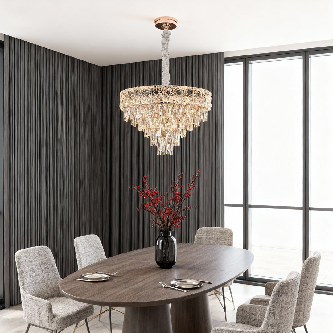 Modern dining room with gold large chandelier crystals over dark wood table.